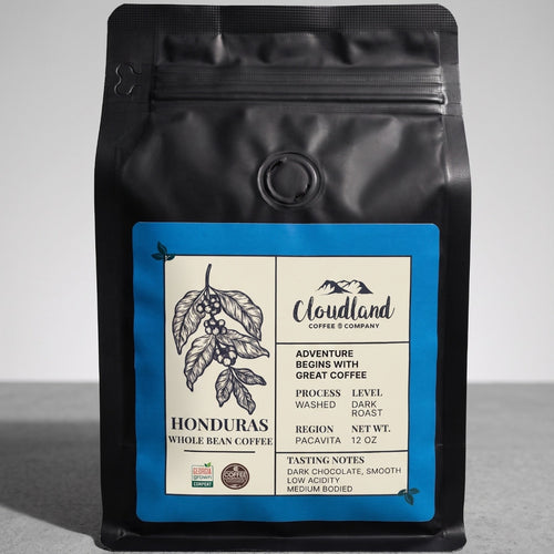 Black coffee bag with a label on a gray background