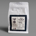 White coffee bag with a decaf coffee label on a gray background